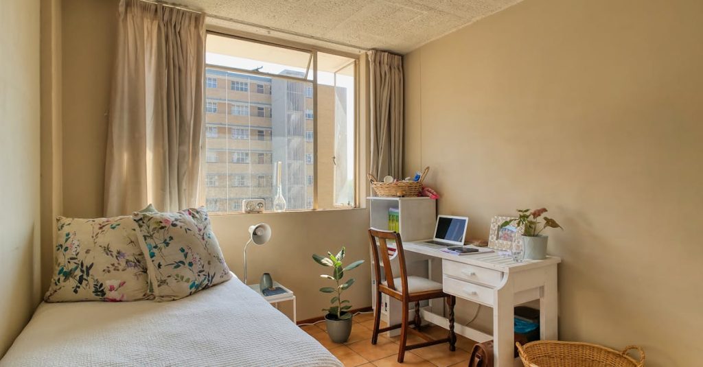 Bright student room with furniture and laptop, ideal study space in Pretoria, South Africa.